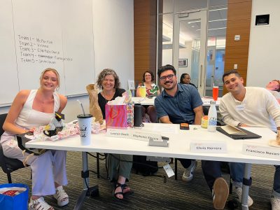 Four graduate students sitting at a table