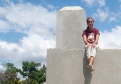 woman sitting on stone structure