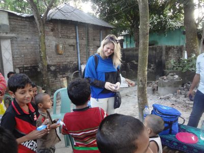 Jess smiling at a group of children