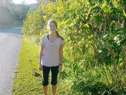 Beth standing next to greenery