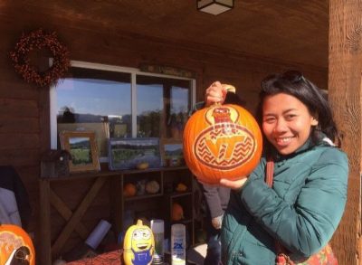 Putu holding a carved pumpkin