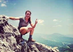 woman climbing on rocks
